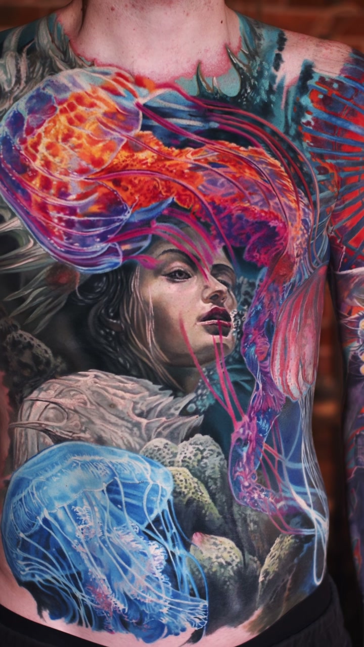 Healed color realism torso tattoo by Alex666cold — woman's face underwater with an orange and a blue jellyfish