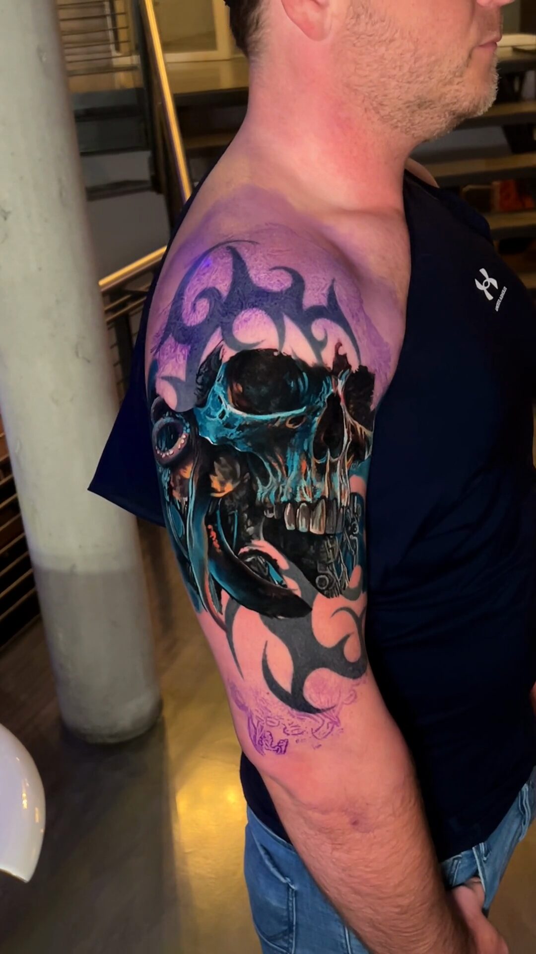 Color realism cover-up by Alex666cold — a realistic skull and octopus over an old black tribal, outer upper arm