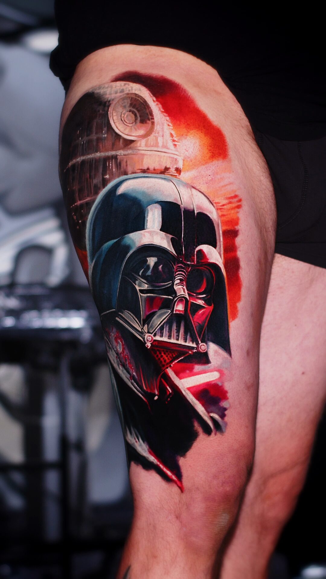 Color realism tattoo by Alex666cold — Darth Vader's helmet, a red Death Star and lightsaber glow, thigh