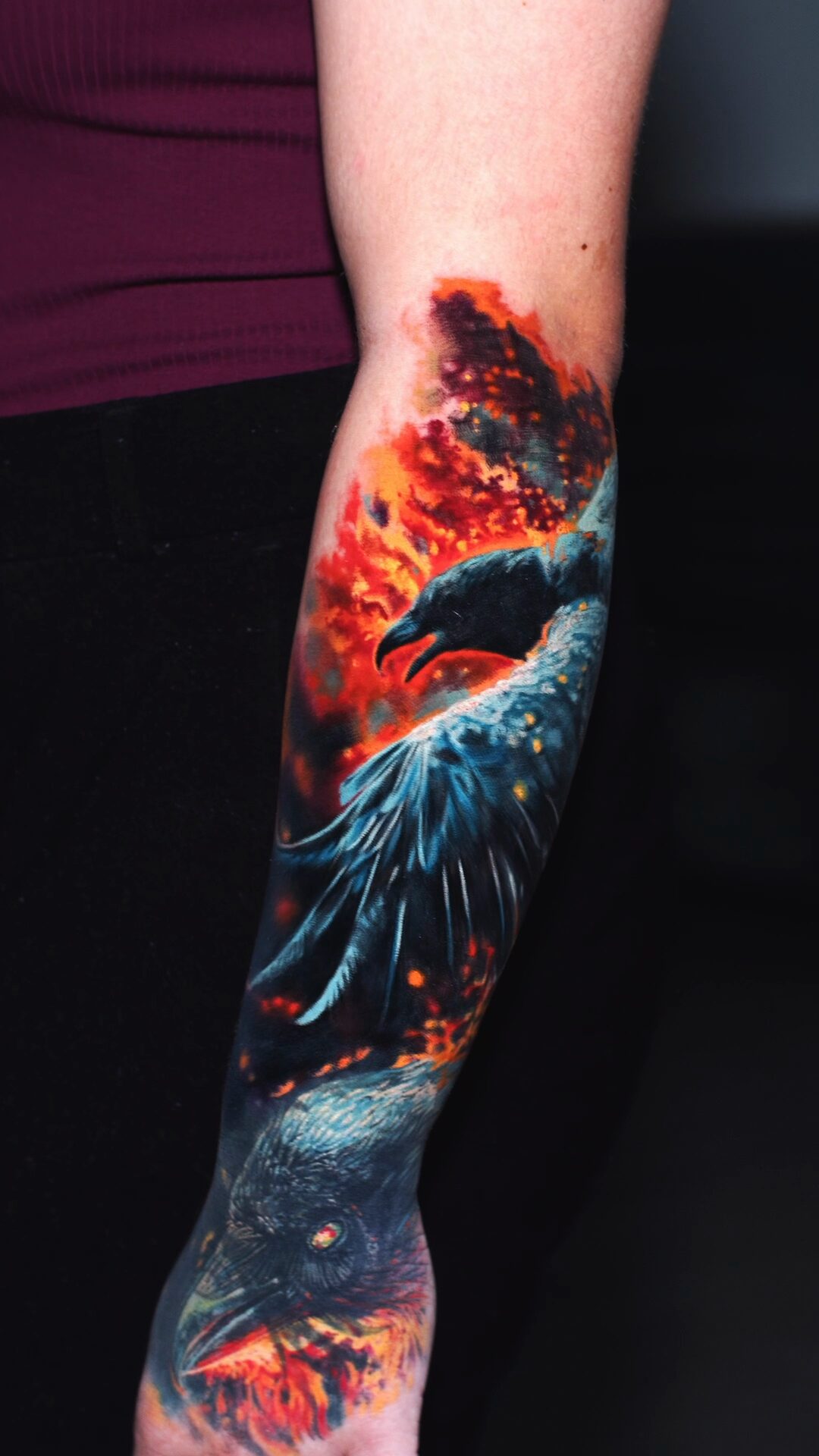 Nahaufnahme von Rabenkopf und ausgebreiteten Flügeln – realistisches Tattoo auf dem Unterarm