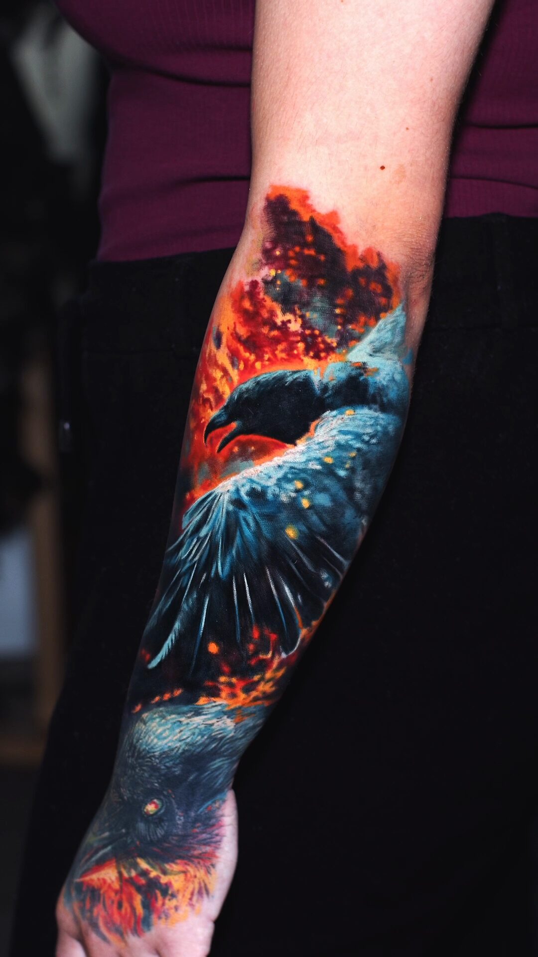 Kleinerer Vogel in Flammen am Handgelenk – Detail des realistischen Tattoos, Alex666cold